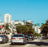 Image of traffic vehicles amidst urban buildings