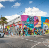 Image of a road with colorful building in the background