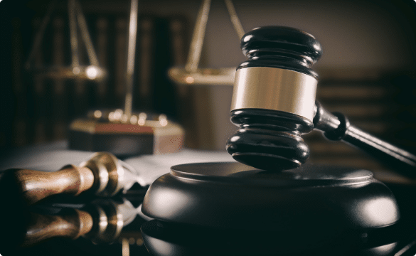 Gavel on a desk, scales of justice are blurred in the background