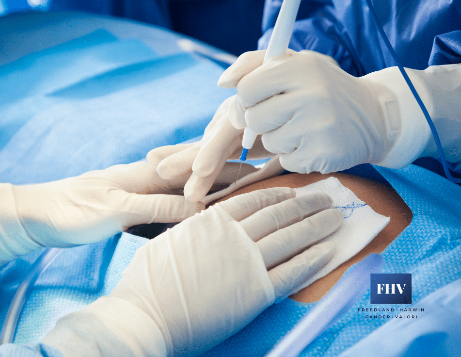 Close up of a doctor starting an incision on woman undergoing a c-section procedure in Florida.