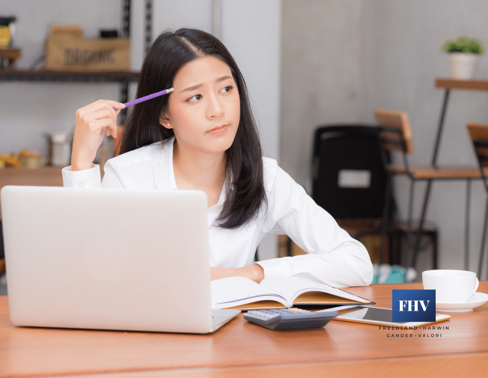 woman sitting at her desk in front of a laptop thinking about her odds of winning a medical malpractice lawsuit